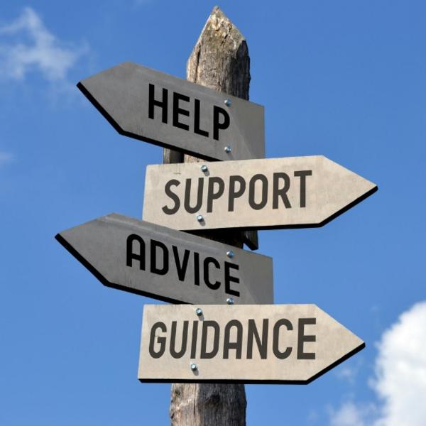A sign post with directional signs reading "Help, Support, Advice and Guidance"