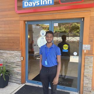 WIL Student Standing in front of Days Inn
