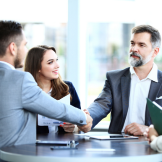 two people shaking hands over business