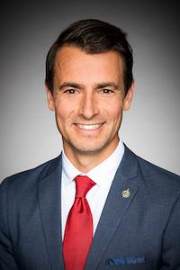 Man in a suit and red tie.