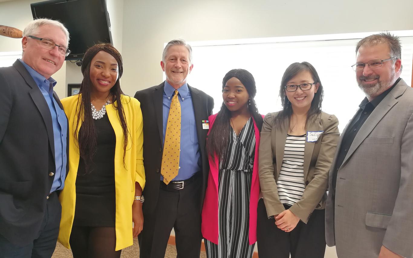 Employers with their interns posing for a photo